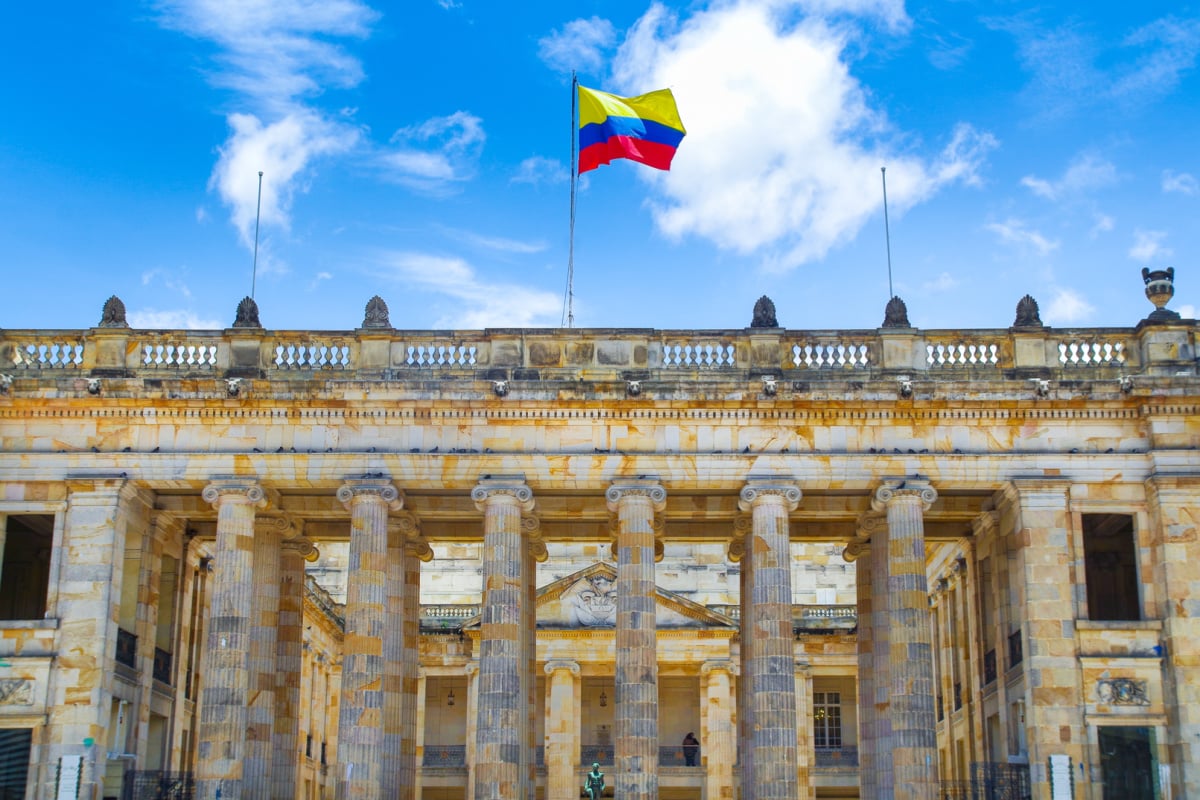 Colombia flag waving over historic building in Bogota